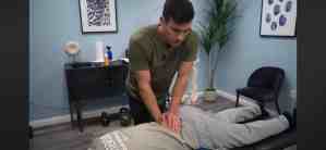 Tyler Bigenho chiropractor performing spinal adjustment on cliet with back pain.jpeg