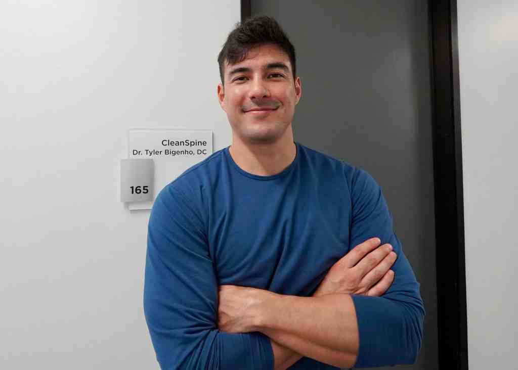 Dr. Tyler Bigenho in front of his office door suite 165