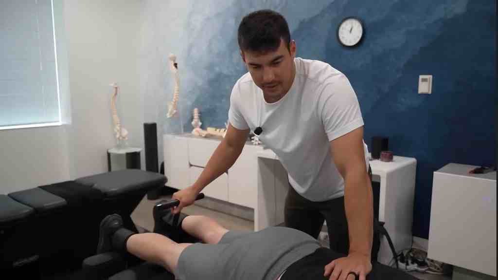 Dr. Tyler Bigenho providing gentle drop-table chiropractic care for low back pain at CleanSpine in Irvine