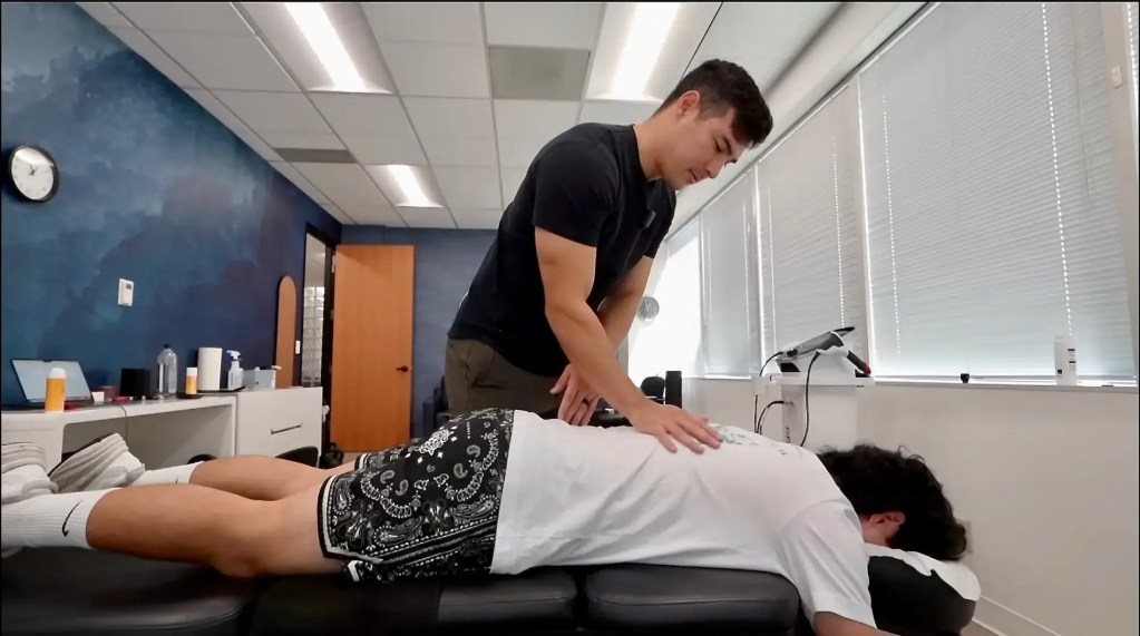 Dr. Tyler Bigenho of CleanSpine performing a chiropractic adjustment on a patient to treat symptoms of degenerative disc disease.